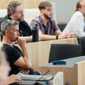 Photo of symposium delegates listening to a presentation