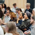 Photo of symposium delegates listening to a presentation