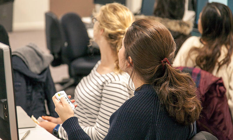 Students with polling handsets during a class. Photo by Xavier L.