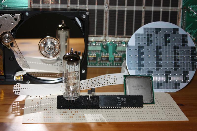 Life sciences tech Images of some early computer parts. At the back: core memory (tiny tiny doughnuts of metal woven onto wires). At the front: A punched card