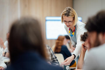 Photo of Dr Tünde Varga-Atkins working with delegates during her workshop