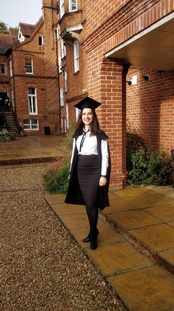 Eva wearing sub fusc and gown on her graduation day