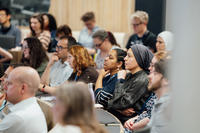 Photo of symposium delegates listening to a presentation